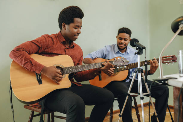 istock Two young African-Americans playing musical instruments at home 1346610170
