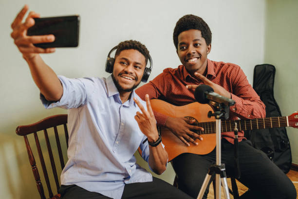 istock Two young African-Americans playing musical instruments at home 1346610536