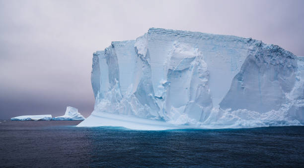 Iceberg in Antartic sea Antarctic iceberg iceberg dramatic sky wintry landscape mountain stock pictures, royalty-free photos & images