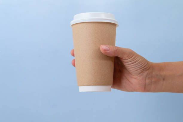 istock Paper cup to go against blue background 1346612796