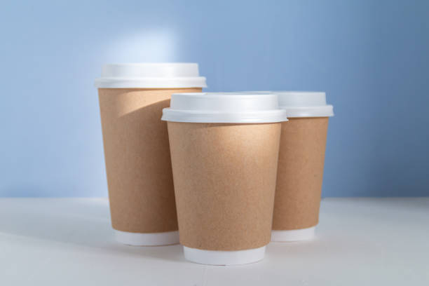 istock Paper cup to go against blue background 1346612824