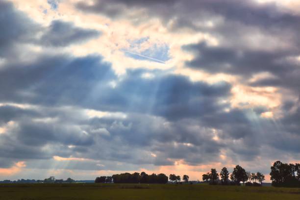 istock Cloudy colourful sunset over Dutch landscape 1346614425