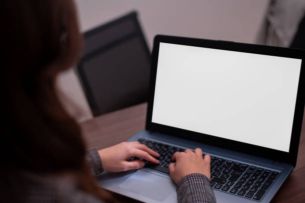 istock Girl typing on her laptop with white screen 1346615370