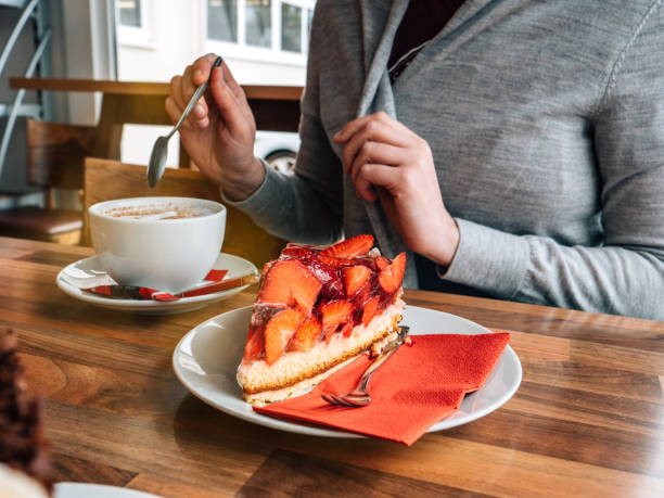 istock Crop woman having coffee with dessert, german cake, 1346615526