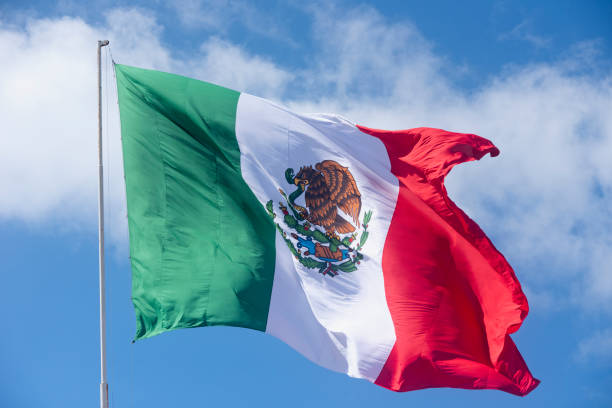 istock Mexico national flag and blue sky 1346616539