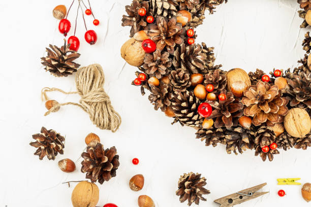 istock Autumn wreath of cones, nuts, and berries. Creative composition, the handmade 1346616695