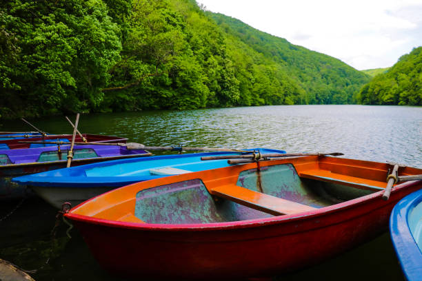 Small pleasure boats on the lake surrounded by greenery