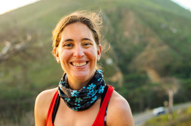 istock Young woman with cerebral palsy smiling during a break from a trail run 1346628537