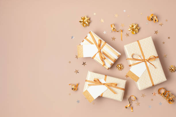 istock Christmas background with gift boxes wrapped in golden colored paper 1346636809