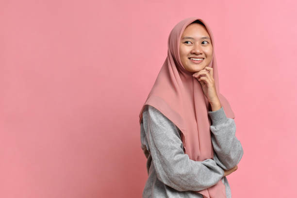 istock Young Asian muslim woman looking at a copy space or thinking an idea 1346645595
