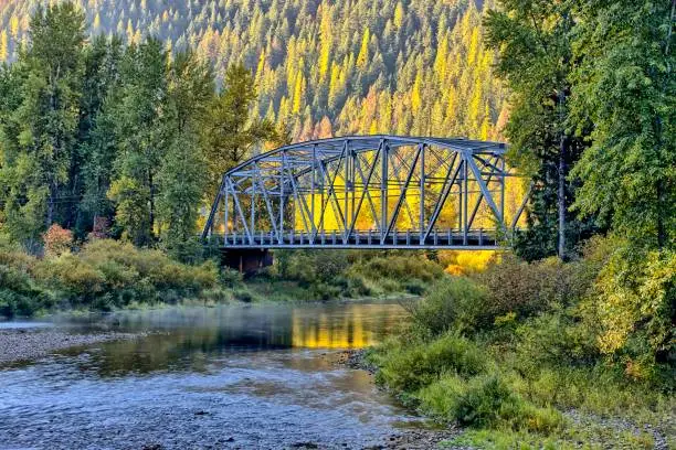 A small automobile bridge spans over a small section of the Coeur d'Alene river in north Idaho.