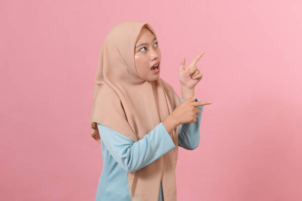 istock Cheerful muslim woman pointing at copy space 1346645901