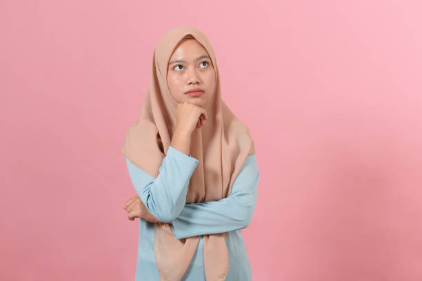 istock Young Asian muslim woman looking at a copy space or thinking an idea 1346645903