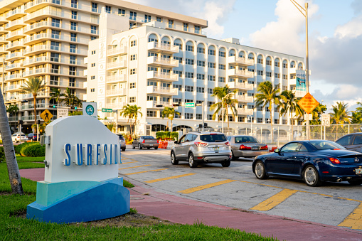 Miami Beach, FL, USA - October 13, 2021: Miami Beach Surfside sign with view of Champlain Towers South collapse site in background