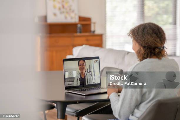 Patient Meeting Remotely With Her Doctor Stock Photo - Download Image Now - Telemedicine, Medical Exam, Healthcare And Medicine