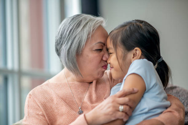 istock Grandmother and Her Granddaughter Making Silly Faces 1346653740