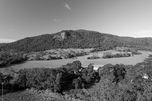 Monotone of the north face of Mount Blackwood at Mackay with a communications tower at its peak