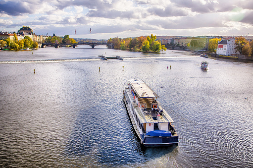 Tour boat pass by Vltava river in old town Prague, Czech Republic