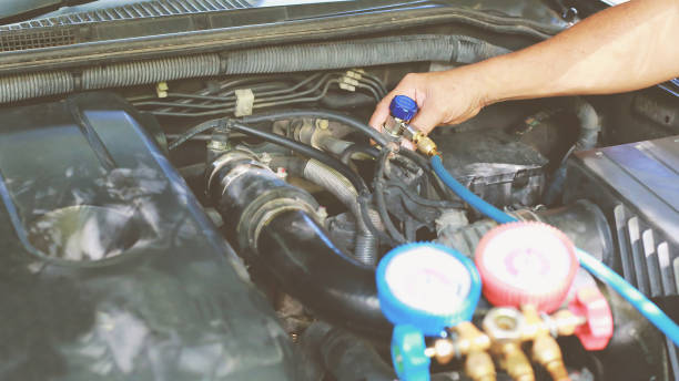 istock Car air conditioner check service, leak detection, fill refrigerant.Device and meter liquid cooling in the car by specialist technicians. 1346661005