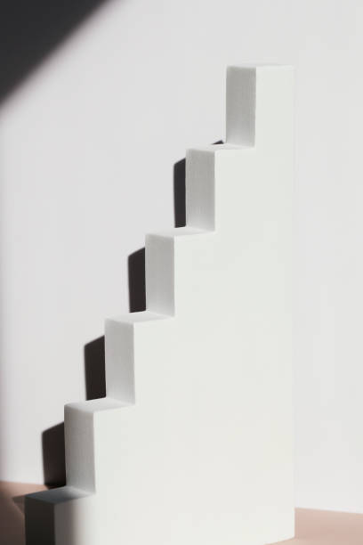 istock White podium in form of step with deep shadow. Pedestal. Stage for product on white background. copy space 1346663712