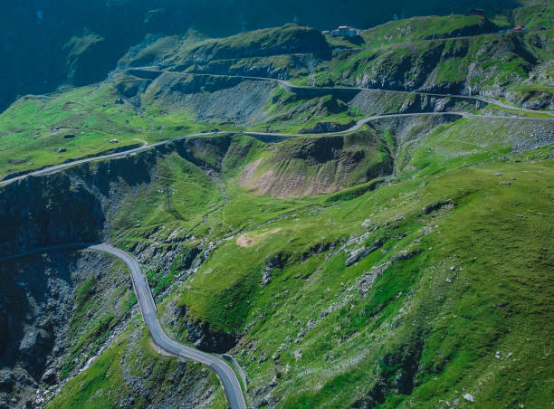 epic winding road on transfagarasan pass in romania in summer time, with twisty road rising up. road crossing fagaras mountain range, noted as one of the best motorable roads in the world. - twisty road imagens e fotografias de stock