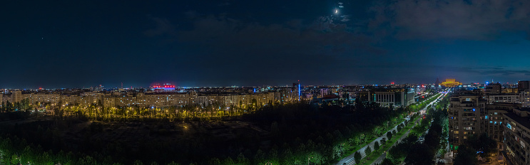 Night panorama of Bucharest wit huge building of parliament in the centre. Romania capital on summer night. Evening view over the avenue looking towards parliament