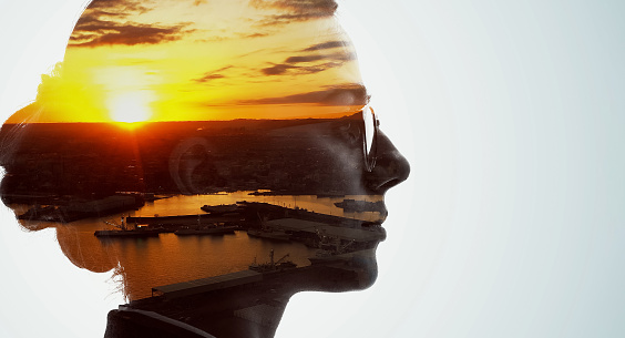 Silhouette of woman and sunset scenery. Double exposure.