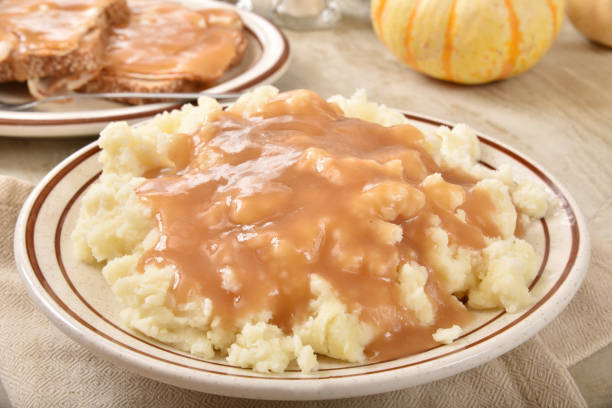 istock Serving bowl of mashed potatoes and turkey gravy 1346672488
