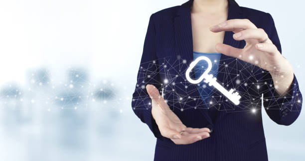 Safety and security concept. Two hand holding virtual holographic key icon with light blurred background. Data protection privacy concept. GDPR. EU.