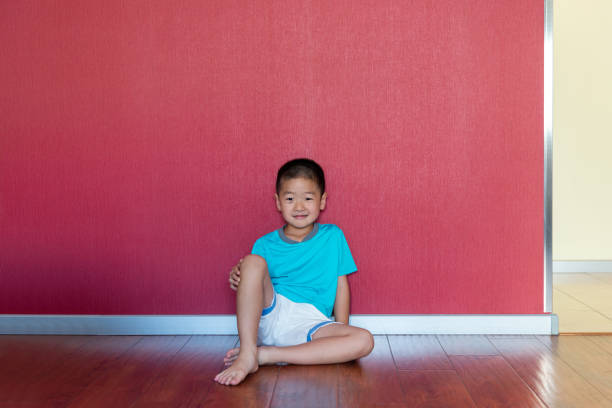 istock Little boy sitting in front of the red wall 1346673844