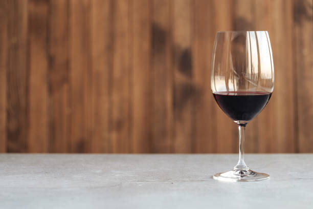 istock Side view on a glass of red wine on the table 1346674394