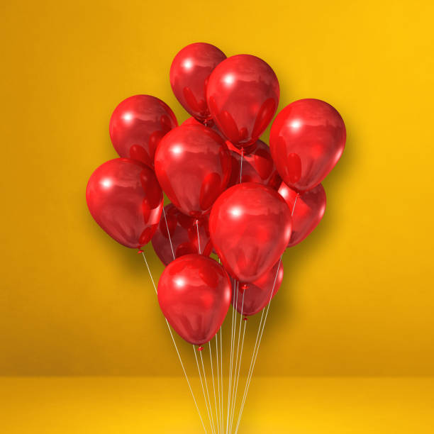 istock Red balloons bunch on a yellow wall background 1346674738