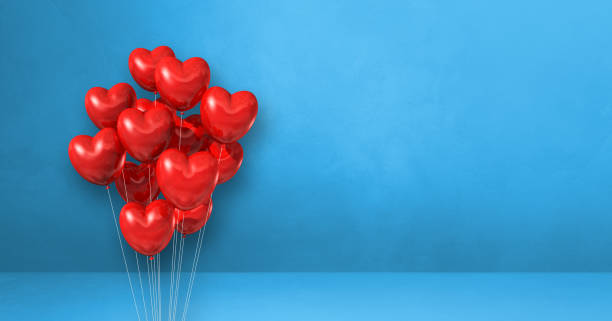 istock Red heart shape balloons bunch on a blue wall background. Horizontal banner. 1346674745
