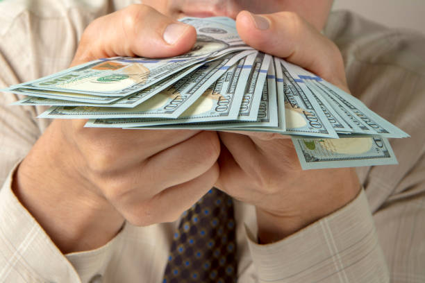 istock Bundle of $100 banknotes in male hands 1346675525