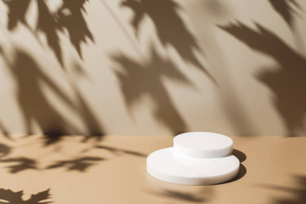istock scene with white podium on beige background and shadows 1346676657