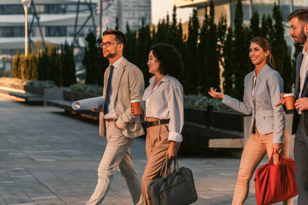 istock Group of business people walking outside in front of office buildings. 1346677708