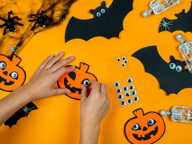 istock Children's hands make a pumpkin with their own hands, preparing for Halloween. 1346679745