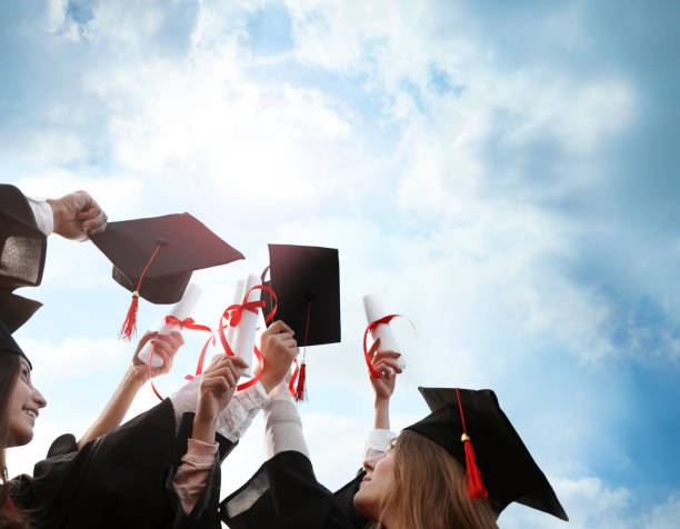 istock Group of students with diplomas outdoors. Graduation ceremony 1346679916