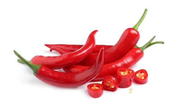 istock Cut and whole red hot chili peppers on white background 1346679947