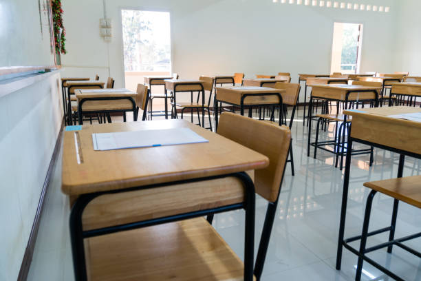istock Education learning problem in future and new normal life, School empty classroom no childrens when COVID-19 disease outbreak and closed quarantine, no pupils in school and student study at home. 1346680278
