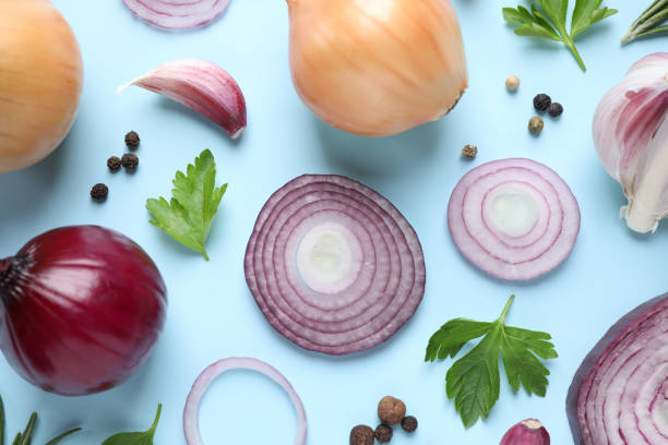 istock Flat lay composition with onion and spices on light blue background 1346681382