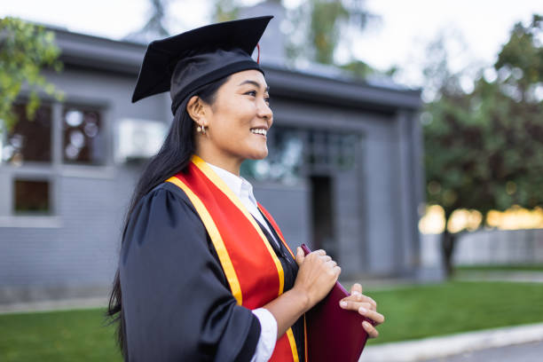 proud female university student graduate - grad portrait imagens e fotografias de stock