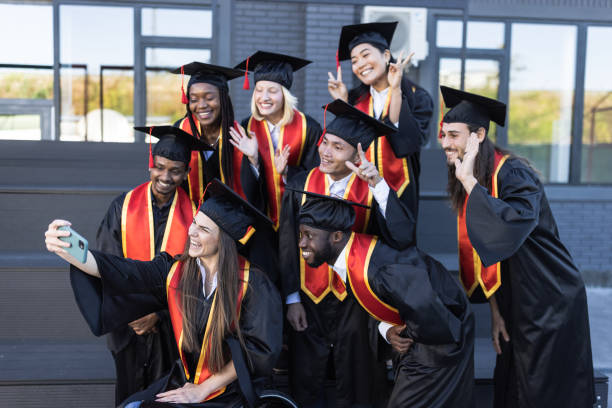 istock University students taking selfie just before the Graduation ceremony 1346684201