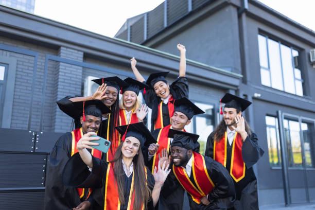 istock University students taking selfie just before the Graduation ceremony 1346684219
