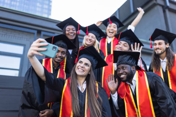 istock University students taking selfie just before the Graduation ceremony 1346684220