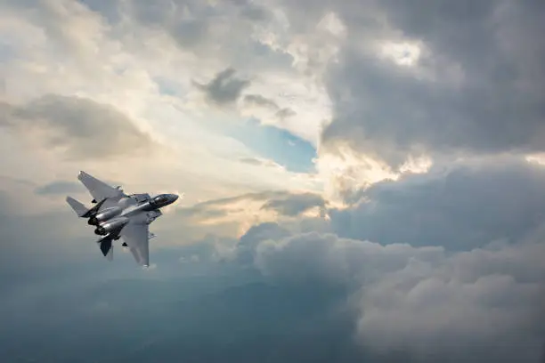 F-15 Fighter Jet flying over clouds