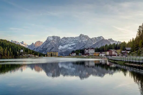 Sunset over Misurina Lake with sky reflection in calm water. View on the majestic Dolomites Alp Mountains, National Park Tre Cime di Lavaredo, Dolomiti Alps, South Tyrol, Italy