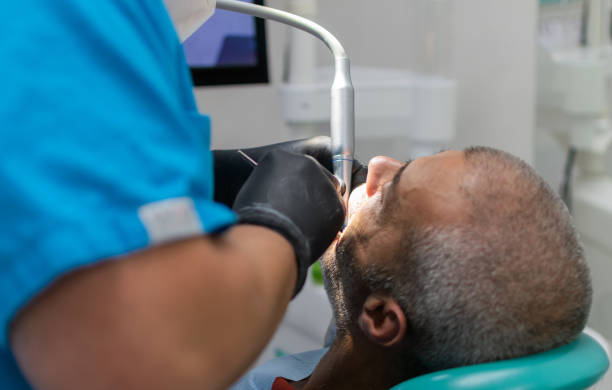 istock Dentist making treatment, senior man sitting having her teeth checked during appointment at dentist's office.Healthcare and medicine concept. 1346685531