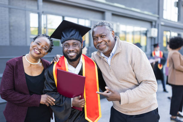 istock African American graduate with proud parents 1346686770