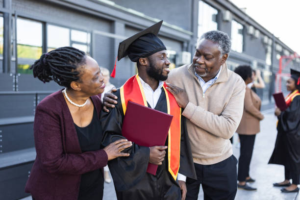 Graduation. African American graduate with proud parents